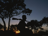 Buy A Silhouetted Man with Rifle Enjoys Sunset at a Private Game Reserve at AllPosters.com