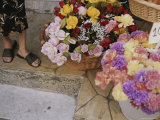 Colorful Flowers Fill Baskets at a Vendors Street-Side Stall