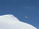 A Twin Otter Plane Flies over Ski Mountaineers Atop Detroit Plateau