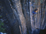 A Young Woman Climbs a Wall in Moab, Utah