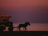 A Horse-Drawn Carriage Rolls Along Jeddahs Waterfront at Sunset
