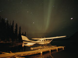Buy The Aurora Borealis Glows Brightly over a Seaplane Docked on Cli Lake at AllPosters.com