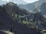Buy A Woman Leads Her Sheep Past Lamayuru Gompa at AllPosters.com