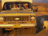 Buy A Dog Stands Outside a Truck with Three Cowboys at AllPosters.com