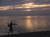 Tahitian Fisherman Walks along the Beach at Sunset