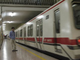 Buy A Commuter on a Platform Next to a Light Rail Train in Beijing at AllPosters.com