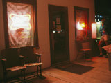 A Woman Uses a Pay Phone at a Bar