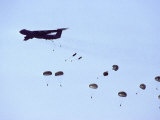 Parachuting Troops Flood Out of the Back of a Transport Plane