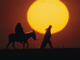 Silhouetted Man Leads a Donkey Bearing a Pregnant Woman, Reminiscent of Joseph and Mary, Israel