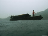Buy Moken Tribesman Holds onto a Line in the Bow of a Kabang in a Storm at AllPosters.com