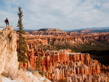 A Hiker Looks off a Cliff at Bryce Canyon Amphitheater, Bryce Canyon National Park, Utah
