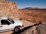 Buy A Sport Utility Vehicle Maneuvers a Tight Corner on a Dirt Trail, Capitol Reef National Park, Utah at AllPosters.com