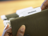 Woman Holding Insurance Folder