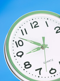 Green and White Ticking Clock
