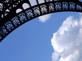A Detailed Arch on the Eiffel Tower Against Blue Sky and Clouds