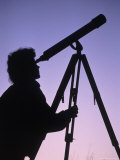 Silhouette of Woman Looking Through Telescope
