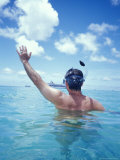 Man Snorkeling and Waving at Cruise Ship