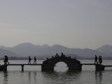 Buy People Crossing a Bridge Over a Lake in Twilight, China at AllPosters.com