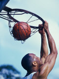Man Slam-Dunking a Basketball