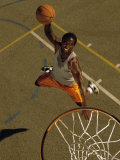 High Angle View of a Basketball Player Slam Dunking a Ball