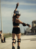 Rear View of a Young Woman Inline Skating on a Road