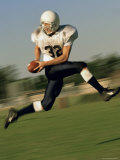 American Football Player Running on a Field