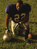 American Football Player Kneeling on the Field