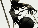 High Angle View of a Basketball Player Slam Dunking a Basketball