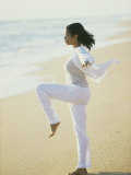 Side Profile of a Young Woman Meditating on the Beach