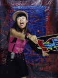 Young Woman Holding Out a Skateboard