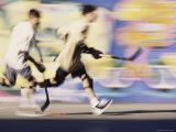 Motion Blurred Image of Teens Playing Street Hockey