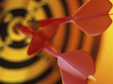 Close-up of Three Darts in the Bull's-Eye of a Dartboard