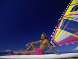 Buy Young Man Sitting on a Surfboard at the Beach at AllPosters.com