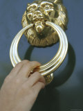 Close-up of a Person's Hand Using a Doorknocker