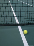 Tennis Ball Resting Near Net