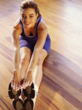 High Angle View of a Young Woman Stretching on the Floor