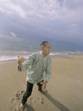 Senior Man Practicing Tai Chi on the Beach