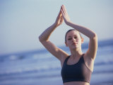 Young Woman Meditating on the Beach