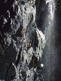 Rock Climber Near a Waterfall
