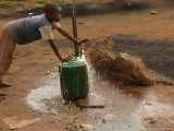 Buy A Child Fills a Container with Water for Domestic Use at AllPosters.com