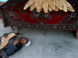 Buy A Beggar Sleeps Next to a Bakery in Kabul, Afghanistan, Wednesday, June 7, 2006 at AllPosters.com