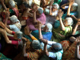 Abandoned Elderly Women Raise Hands During a Prayer Meeting