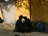 A Barber Cuts the Beard of a Client in His Barber Post in Kabul, Afghanistan, October 1, 2006
