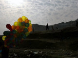 Buy A Boy Walks as Selling Balloons in a Neighborhood in Kabul, Afghanistan, Thursday, August 24, 2006 at AllPosters.com