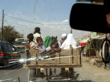 Buy Afghans Sit in the Back of a Cart on the Outskirt of Kabul, Afghanistan, September 28, 2006 at AllPosters.com
