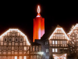 Buy A Huge Christmas Candle Appears Above the Roofs in the Old City of Schlitz, Germany at AllPosters.com