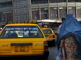 Buy An Afghan Woman Clad in a Burqa Walks Next to a Taxi in Kabul, Afghanistan, Wednesday, June 7, 2006 at AllPosters.com