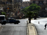 An Iraqi Boy Runs Across a Deserted Street