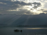 Buy A Kashmiri Fisherman Rows His Boat at Dawn on the Dal Lake, Srinagar, India, Tuesday, April 5, 2005 at AllPosters.com