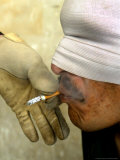 An American Soldier Gives a Smoke to an Iraqi Detainee after a Search Operation